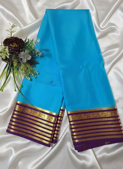 Pure Mysore Crepe Silk - Capri Blue with Purple Peacock Motifs Border